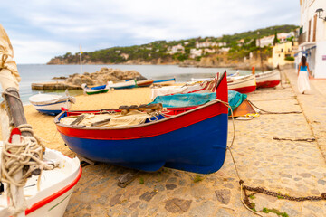 Obraz premium Colorful fishing boats on the sandy beach at the Costa Brava fishing village of Calella de Palafrugell, Spain.