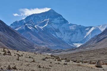 Majestic view of Mount Everest from the North Base Camp in Rongbuk, Tibet, showcasing snow-capped peaks, rugged terrain, and a clear blue sky &ndash; perfect for nature, travel, and adventure photography.