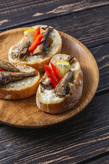 fish sandwich with butter and sprats lemon and red pepper