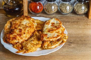cooked chicken chops on a white plate on the table