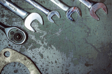 Wrench. Metal background with scratches. Garage service. Tools for repair. Free space for inscriptions.