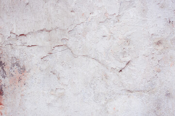 White concrete wall with natural defects. Fragment of the cement surface with natural texture. Monochrome palette of shades.