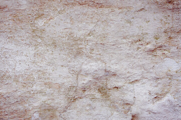 White concrete wall with natural defects. Fragment of the cement surface with natural texture. Monochrome palette of shades.