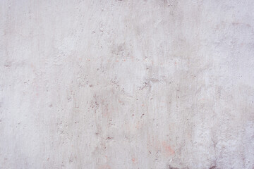 White concrete wall with natural defects. Fragment of the cement surface with natural texture. Monochrome palette of shades.