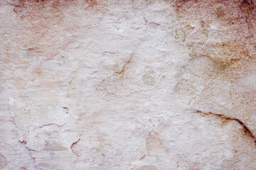 White concrete wall with natural defects. Fragment of the cement surface with natural texture. Monochrome palette of shades.