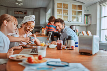 Happy family enjoying breakfast together in kitchen