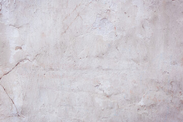 White concrete wall with natural defects. Fragment of the cement surface with natural texture. Monochrome palette of shades.