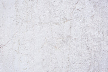 White concrete wall with natural defects. Fragment of the cement surface with natural texture. Monochrome palette of shades.