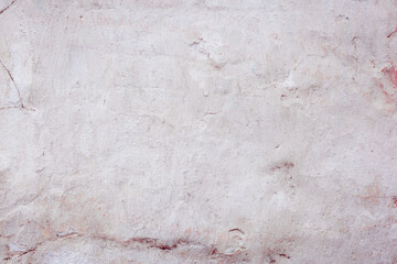 White concrete wall with natural defects. Fragment of the cement surface with natural texture. Monochrome palette of shades.