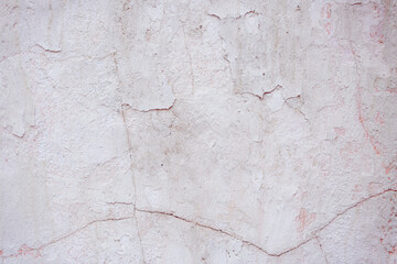 White concrete wall with natural defects. Fragment of the cement surface with natural texture. Monochrome palette of shades.