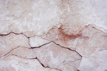 White concrete wall with natural defects. Fragment of the cement surface with natural texture. Monochrome palette of shades.