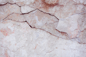 White concrete wall with natural defects. Fragment of the cement surface with natural texture. Monochrome palette of shades.