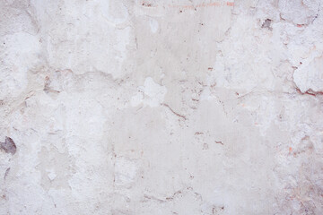 Grey peeling wall with natural defects. Fragment of the concrete shabby surface with natural...