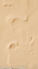 Abstract warm beige rock wall background with textured surface and earthy tones, wall