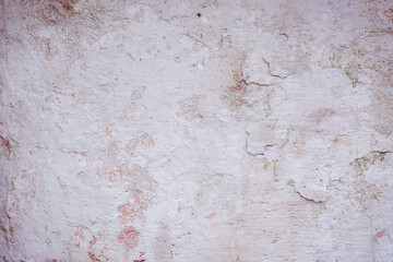 Grey peeling wall with natural defects. Fragment of the concrete shabby surface with natural texture. Red white palette of shades.