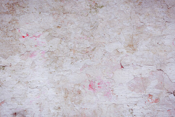 Grey peeling wall with natural defects. Fragment of the concrete shabby surface with natural texture. Red white palette of shades.