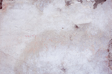Grey peeling wall with natural defects. Fragment of the concrete shabby surface with natural...
