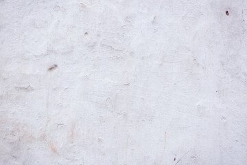 Grey peeling wall with natural defects. Fragment of the concrete shabby surface with natural texture. Red white palette of shades.