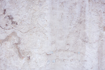 Grey peeling wall with natural defects. Fragment of the concrete shabby surface with natural...