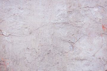 Grey peeling wall with natural defects. Fragment of the concrete shabby surface with natural texture. Red white palette of shades.