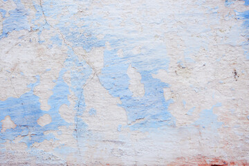 Blue peeling wall with natural defects. Fragment of the concrete shabby surface with natural texture. Blue white palette of shades.