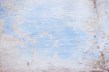 Blue peeling wall with natural defects. Fragment of the concrete shabby surface with natural texture. Blue white palette of shades.