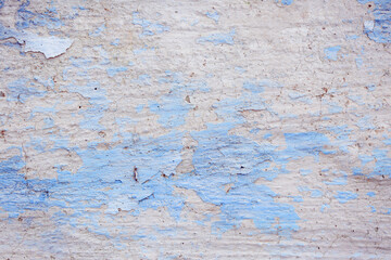 Blue peeling wall with natural defects. Fragment of the concrete shabby surface with natural texture. Blue white palette of shades.