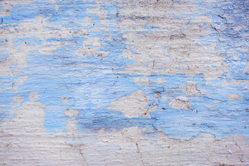 Blue peeling wall with natural defects. Fragment of the concrete shabby surface with natural texture. Blue white palette of shades.