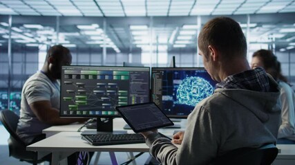 Computer scientist in data center uses artificial intelligence neural networks doing computing processes. IT specialist working on tablet with AI machine learning algorithms, camera B