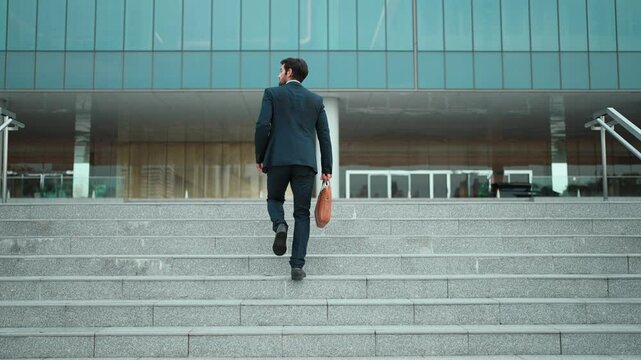 Successful business man leg walking up to stair while going to office. Manager changing workplace, discover a new thing, growth or getting promotion or walking in to light. Back view. Exultant.