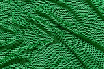Close-up image of green mesh fabric with a wavy texture, showcasing an intricate pattern, perfect for background, textile, or design inspiration purposes.