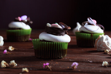 Easter cake on the festive table. Festive pastries with wild spring colors on a dark wood...