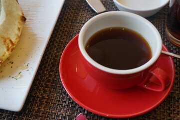 red cup of coffee and a cake