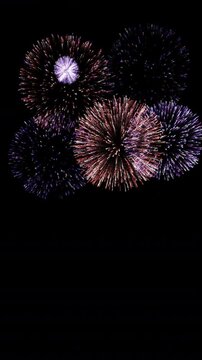 VERTICAL VIDEO, Fireworks background. abstract shining glowing fireworks show. Isolated transparent background, Alpha channel ready.