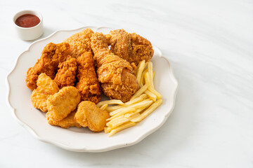 fried chicken with french fries and nuggets on plate