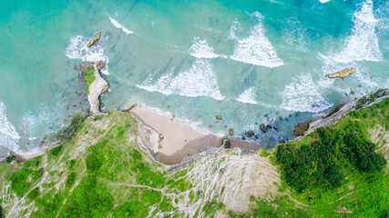 Aerial view of clear turquoise water near a tropical island © Balnyes Visuals