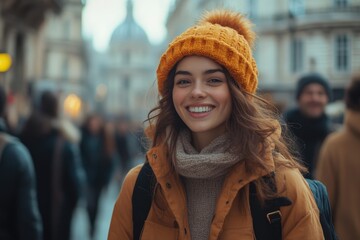 Smiling woman in a yellow hat and scarf standing in a crowded street