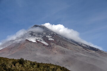 Cotopaxi Volcano erupting with a small ash plume in Cotopaxi National Park, outside of Machachi, Ecuador