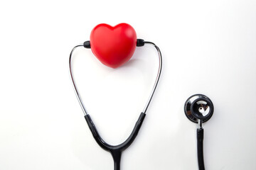 Red decorative heart and stethoscope isolated on white background