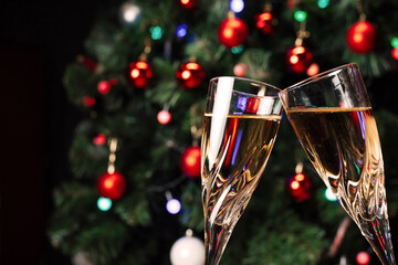 Glasses of sparkling champagne on the background of a decorated Christmas tree. New year mood