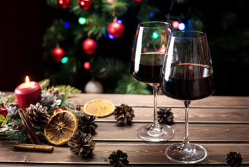 Glasses of wine on the background of a decorated Christmas tree. New year mood