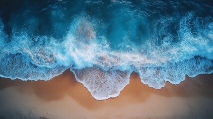 Aerial view of sea waves on beach sand