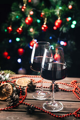 Glasses of wine on the background of a decorated Christmas tree. New Year