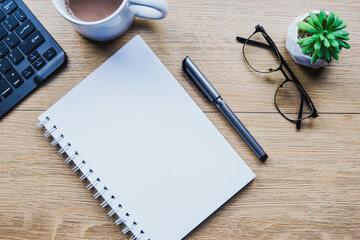 Top view from above of blank open note and office accessories. Business-finance or education concept with copy space.