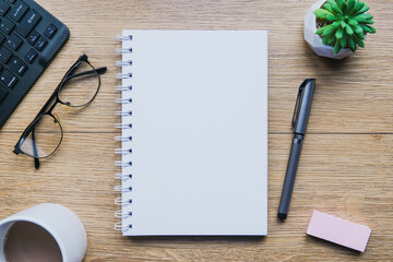 Top view from above of blank open note and office accessories. Business-finance or education concept with copy space.