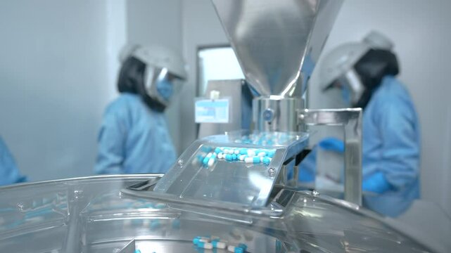 capsules close up. pills moving on a machine. capsule pill making process in a pharma factory. Pharmaceutical manufacturing tablet pill production line. medicine drug tablets capsule on medical device