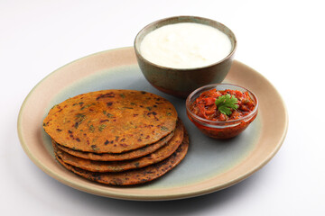   Indian flat bread Methi paratha or Methi thepla is a Indian breakfast dish served with curd and tomato chutney or dip 