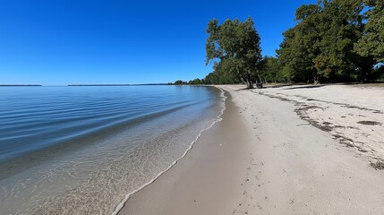 Obraz premium Open sandy beach: A beach and sea without people or other objects in view