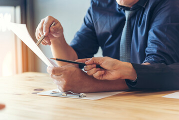 Businessman hands holding note meeting document reading business paper conference room. Man wear...