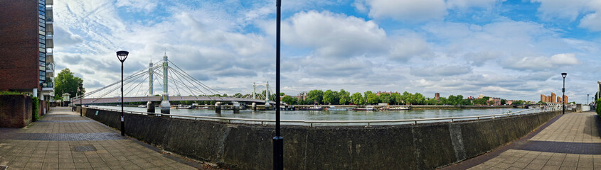 Obraz premium Wide Angle Panoramic Central Chelsea London city on river Thames Albert Bridge Road England United Kingdom. Low Angle High Resolution Image Was Captured on June 3rd, 2024